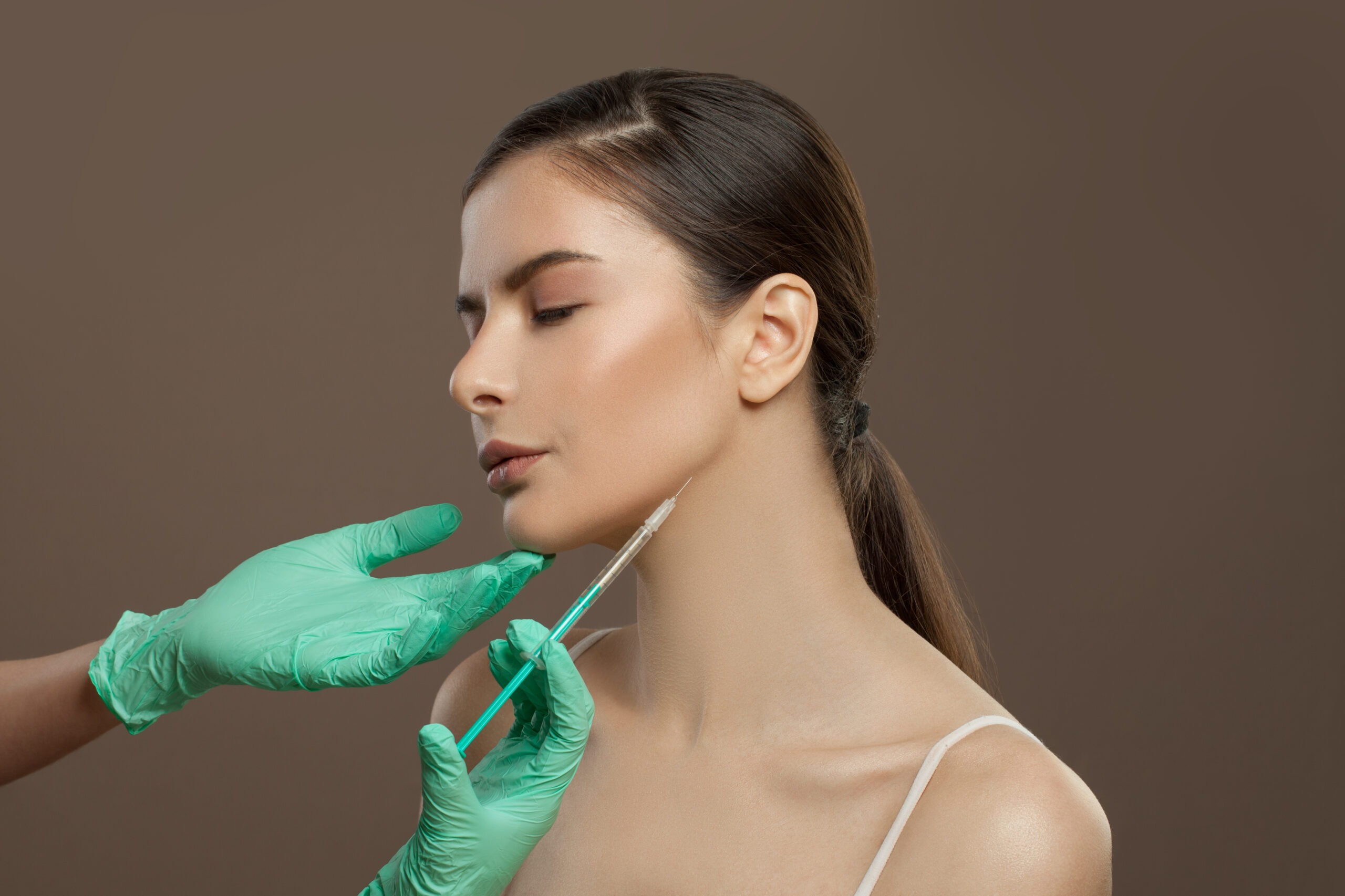 Biostimulatory injectable being administered to jawline