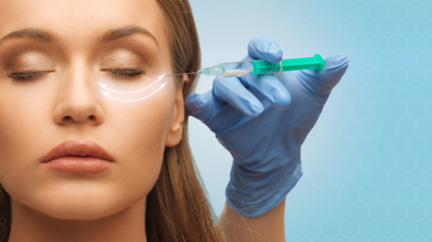 Woman receiving under-eye filler for hollow tear troughs