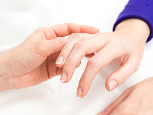 Dermatologist assessing aging hands before hand rejuvenation treatment
