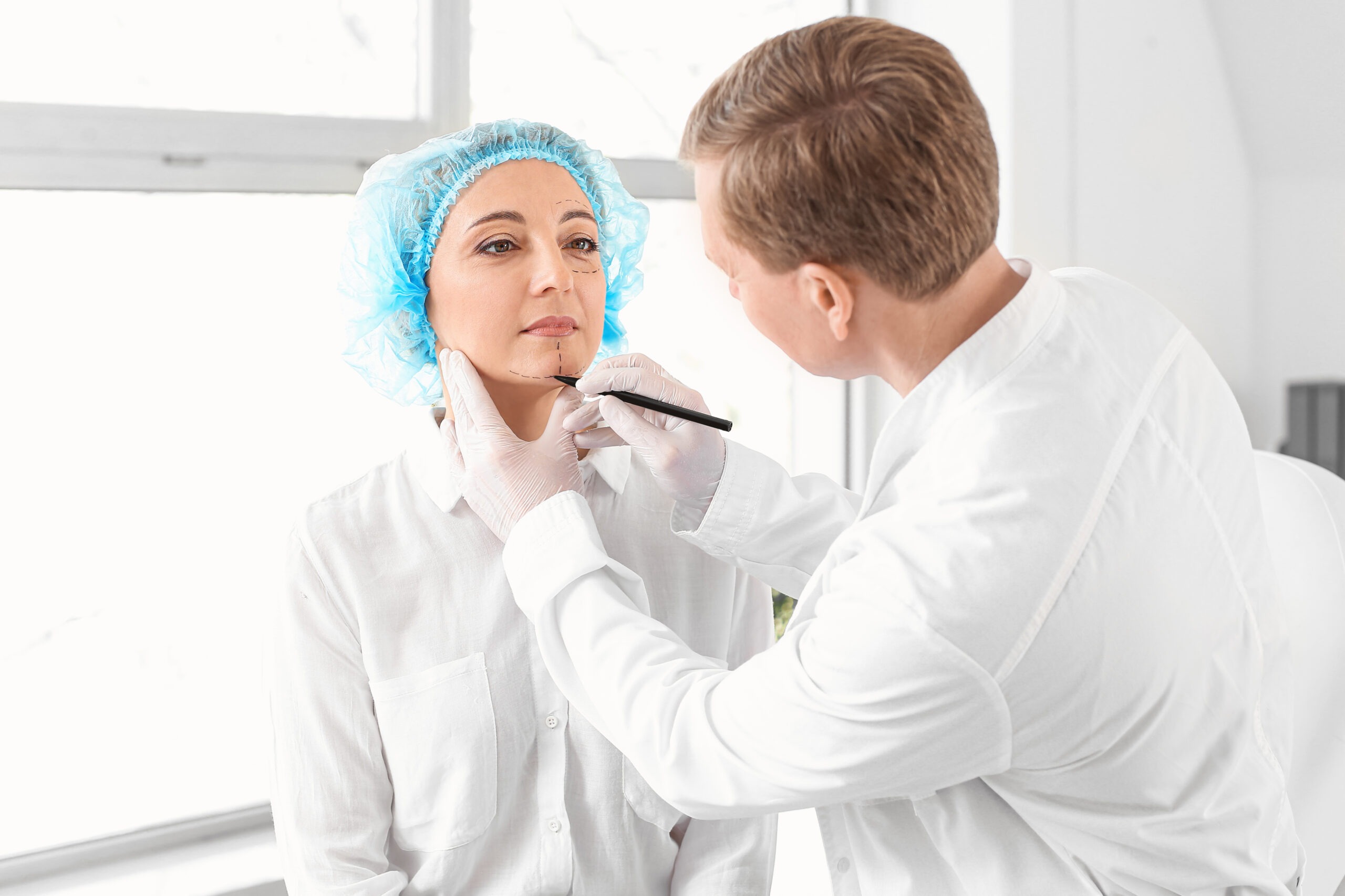 Doctor performing jawline contouring at Reveal Clinics Riyadh