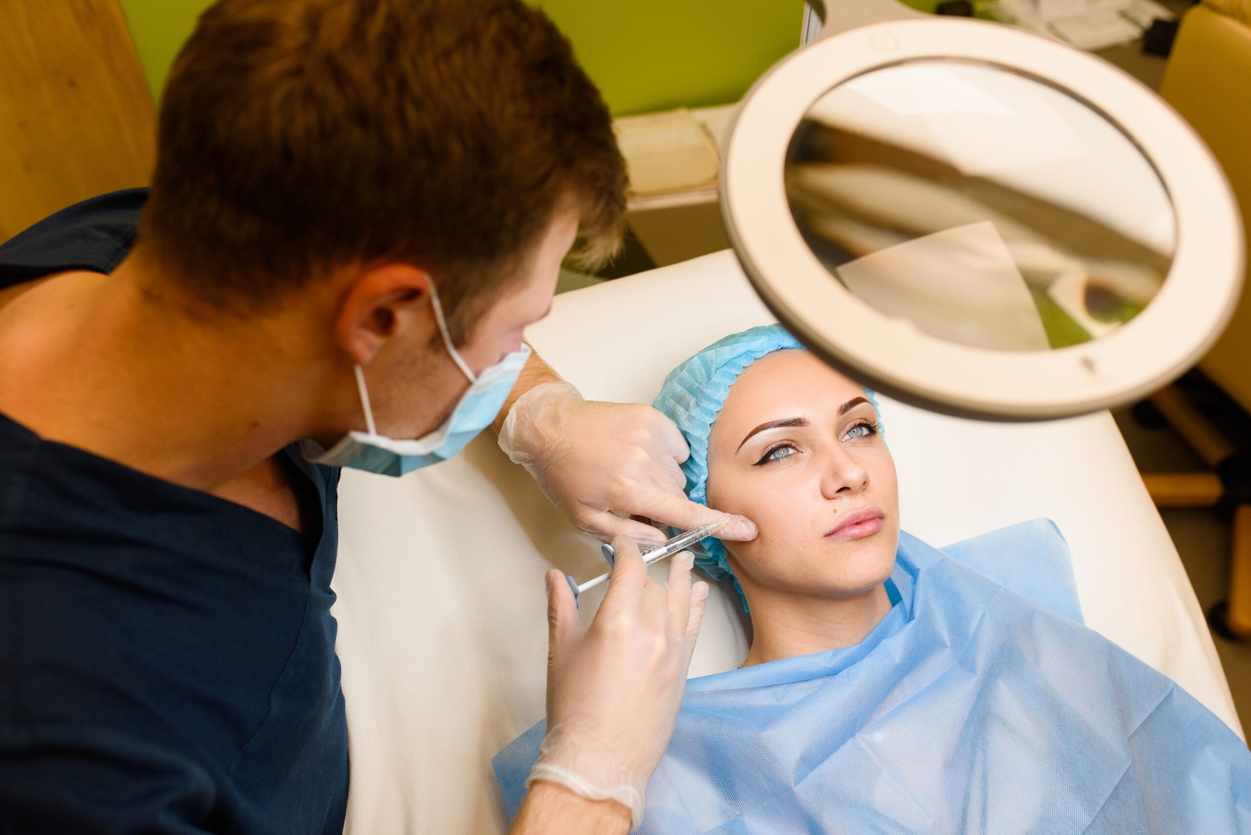 Aesthetic doctor performing cheek filler treatment